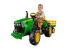 a child sits on top of the John Deere 12 Volt Ground Force Tractor with Trailer