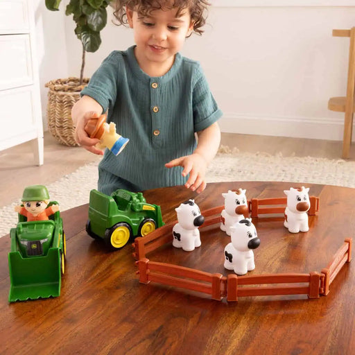 child playing with John Deere The Cows Are Out – Farm Toy Playset